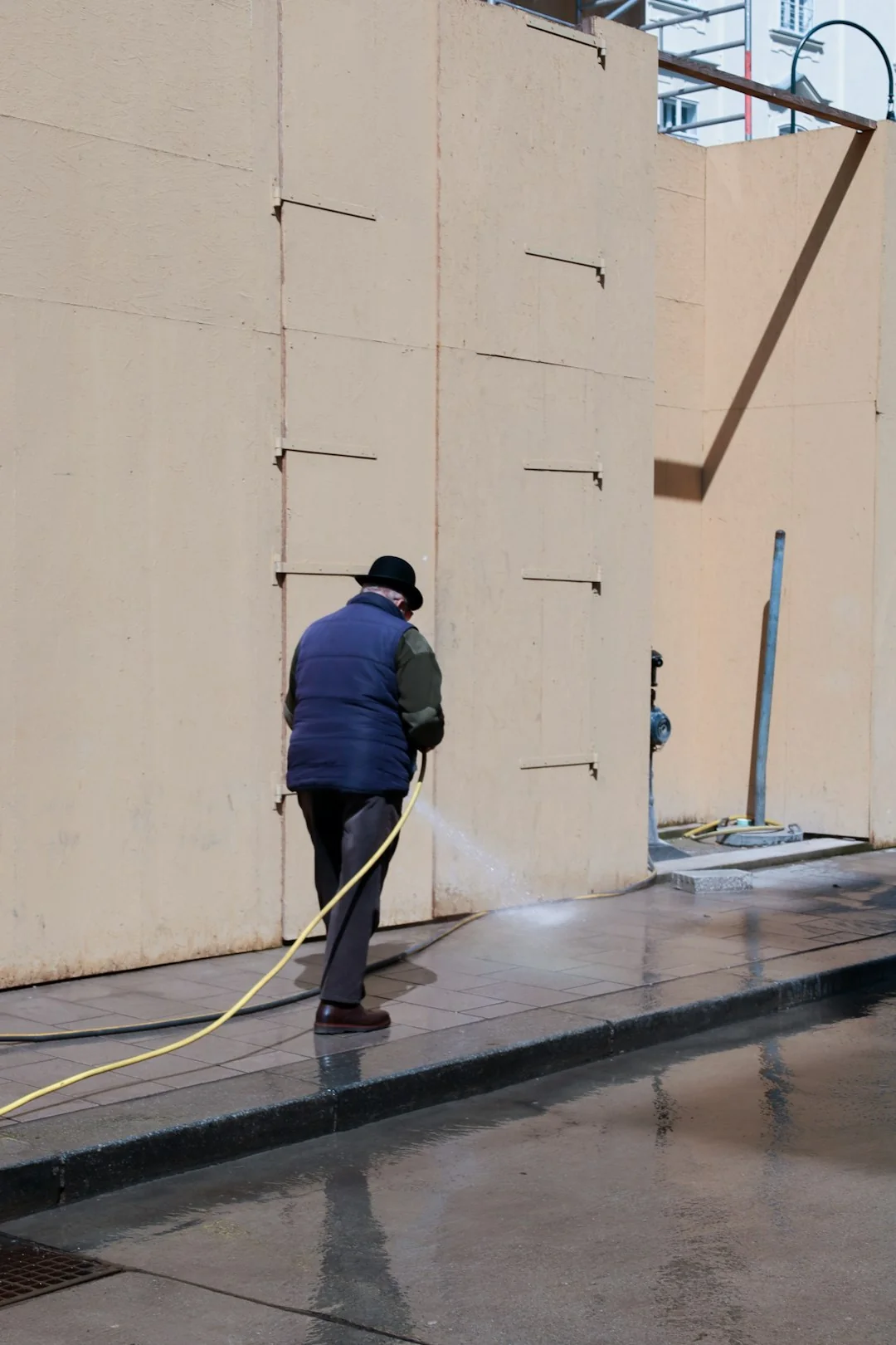 Professional window cleaners working on a skyscraper in Abu Dhabi, showcasing urban architecture.